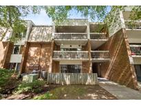 Brick condo building with multiple balconies and well-maintained landscaping at 500 Umstead Dr # 103C, Chapel Hill, NC 27516