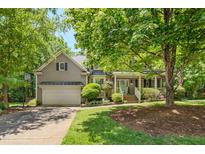 Charming two-story home with a covered front porch, manicured landscaping, and an attached two-car garage at 6 Gasper Ct, Durham, NC 27713