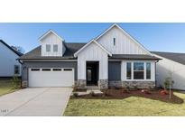 Charming two-story home with a two-car garage and manicured front yard at 61 Wabash Way, Pittsboro, NC 27312