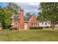 Charming brick home featuring a well-maintained front yard and a classic architectural design at 701 E Nash St, Spring Hope, NC 27882