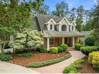 Charming home with inviting brick-and-siding facade and lush landscaping at 74002 Harvey, Chapel Hill, NC 27517
