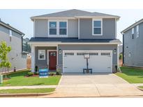 Charming two-story home featuring a spacious two-car garage, a red front door, and a well-manicured lawn at 809 Ottawa Dr, Garner, NC 27529