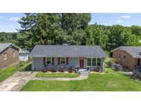 Charming single-story home with a well-maintained lawn, red shutters and matching front door at 1007 Ancroft Ave, Durham, NC 27713