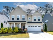 Charming two-story home with a well-manicured lawn, attached garage, and lovely landscaping at 108 Valley View Dr, Chapel Hill, NC 27516