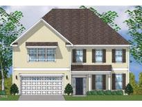 Charming two-story home featuring a large garage, front door, and manicured landscaping at 15 Guardian St, Youngsville, NC 27596