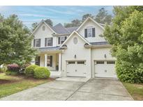 Beautiful two-story home with a well-maintained lawn and a two-car garage at 210 Bennington Pkwy, Durham, NC 27713