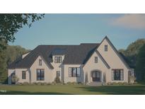 Charming two-story home featuring light brick, a dark roof, and manicured landscaping at 33 Versailles Ln, Pittsboro, NC 27312