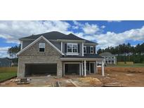 Two story home with a two-car garage and brick and vinyl siding at 40 Accord Dr, Youngsville, NC 27596