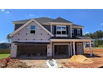 Exterior of a two-story home under construction, featuring a spacious open garage and classic architectural details at 40 Accord Dr, Youngsville, NC 27596