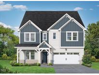 Charming two-story home showcasing a well-manicured lawn and a covered entryway leading to an attached two-car garage at 452 Golden Dragonfly St, Wake Forest, NC 27587