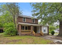 Charming two-story brick home with a welcoming front porch and mature trees at 500 Cokey Rd, Rocky Mount, NC 27801