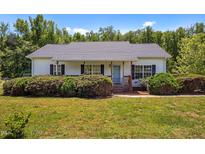 Charming single story home features a cozy front porch and mature landscaping at 5013 W Pool Rd, Rougemont, NC 27572