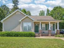 Charming single-story home with a well-manicured lawn and inviting porch at 649 Flaherty Ave, Wake Forest, NC 27587