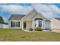 Charming single-story home featuring a bay window, manicured lawn, and attached one car garage at 6921 Peppermill Way, Rocky Mount, NC 27804