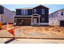 Two-story home featuring navy siding, a white trim, and an attached garage during the final phase of construction at 749 Deschutes Dr, Garner, NC 27529