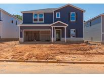 Two-story home with blue siding, an attached garage, and a covered front porch is under construction at 749 Deschutes Dr, Garner, NC 27529