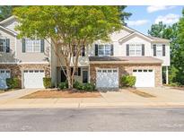 Charming townhome with stone accents, attached garage, and mature landscaping at 8253 Martello Ln, Raleigh, NC 27613
