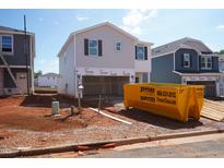 New construction home with light siding, black shutters and an unfinished front yard at 833 Ottawa Dr, Garner, NC 27529
