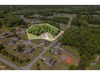 Expansive aerial view of property with mature trees, landscaping, and charming single Gathering home at 91 Carsons Creek Trl, Wendell, NC 27591