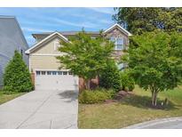 Charming two-story home with stone and siding, landscaped yard and two-car garage at 1009 Magnolia Leaf Ct, Apex, NC 27502