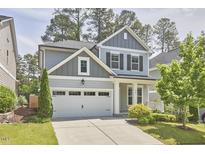 Charming two-story home featuring a two-car garage, well-maintained lawn, and a beautifully landscaped front yard at 120 Chapel Run Way, Chapel Hill, NC 27517