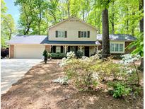 Inviting two-story home featuring a front porch, attached garage, and a charming landscaped front yard at 125 Amesbury Ln, Cary, NC 27511