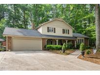 Charming home featuring a front porch, brick accents and a spacious two-car garage at 125 Amesbury Ln, Cary, NC 27511