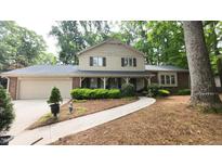 Charming two-story home with manicured landscaping and a welcoming walkway at 125 Amesbury Ln, Cary, NC 27511