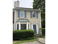 Charming townhome with blue shutters, bay window, and well-maintained landscaping at 210 Standish Dr Dr, Chapel Hill, NC 27517