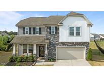 Charming two-story home with a blend of stone and siding accents, plus a two-car garage at 25 Gallery Park Dr, Franklinton, NC 27525