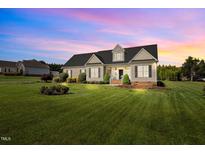 Charming single-story home with a beautifully manicured lawn and mature landscaping at 281 Derwin Dr, Timberlake, NC 27583