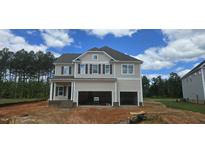 Two-story home featuring a two-car garage and neutral siding, with landscaping potential at 30 Bold Dr, Youngsville, NC 27596