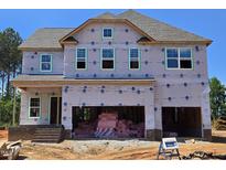 New construction home with a two-car garage and visible framing, set against a clear blue sky at 30 Bold Dr, Youngsville, NC 27596
