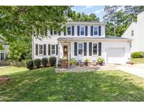 Traditional two-story home with white siding, black shutters, and a well-manicured lawn at 311 Pate St, Apex, NC 27502