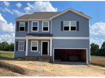 Charming two-story home featuring a two-car garage and a beautifully designed exterior with many windows at 315 Alice Trace Place, Angier, NC 27501