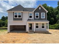 Two-story home with gray siding, a covered entryway, and an attached two-car garage at 316 Alice Trace Place, Angier, NC 27501