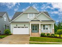 Charming two-story home with a covered porch, two-car garage, and manicured lawn, ideal for curb appeal at 328 Boone St, Chapel Hill, NC 27516