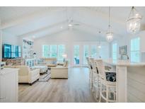 Bright open-plan living room with vaulted ceilings, modern furnishings, and access to the outdoor space at 328 Boone St, Chapel Hill, NC 27516