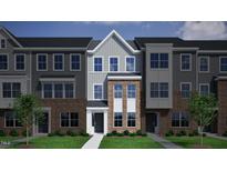 Charming townhome with gray and brick exterior, neat lawn, and welcoming entrance at 368 Chesapeak Commons St # 132, Garner, NC 27529