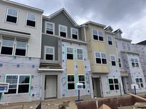 New construction townhomes featuring multiple stories and large windows awaiting final touches at 368 Chesapeak Commons St # 132, Garner, NC 27529