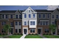 Charming two-story townhome with brick and gray siding, nestled in a landscaped community at 376 Chesapeak Commons St # 130, Garner, NC 27529
