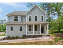 Charming two-story home with a welcoming front porch and gray siding at 509 Olive Branch Rd, Durham, NC 27703