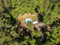 Secluded home with pool and surrounded by mature trees, offering privacy and a natural setting at 525 Turtle Creek Farm Rd, Apex, NC 27523