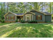 Well-maintained home with a bay window, shutters, and a manicured lawn at 8409 Crowder Rd, Raleigh, NC 27603