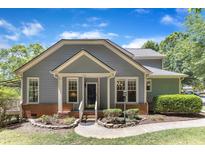 Charming home with a well-maintained lawn, beautiful landscaping, and a welcoming front entrance at 1201 Red Beech Ct, Raleigh, NC 27614