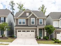 Charming two-story home with a two-car garage and landscaped front yard at 1380 Channing Park Cir, Cary, NC 27519