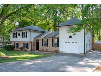 Charming two-story home featuring brick accents, light siding, attached garage and a well-maintained lawn at 1700 Laura Duncan Rd, Apex, NC 27502