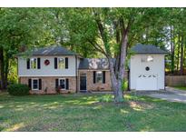 Charming two-story home with brick accents, well-maintained lawn, and mature trees offering shade and curb appeal at 1700 Laura Duncan Rd, Apex, NC 27502