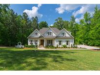 Charming two-story home with landscaped front yard and walkway to a covered porch at 197 Boxwood Dr, Pittsboro, NC 27312