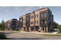 Modern brick townhome with rooftop terrace, black accents, and well-maintained landscaping along the walkway at 210 Byrum St # 6, Cary, NC 27511